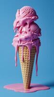 Melting pink ice cream scoops on waffle cone against blue background photo