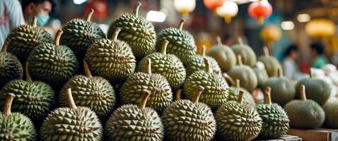 A pile of durians are on display at a market. photo