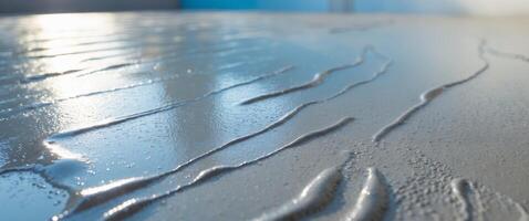 Wet cement with a glossy surface reflecting a bright background photo
