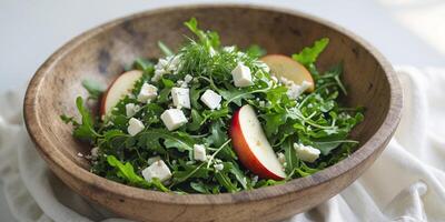 Rocket Salad with Feta Cheese Apples and Fresh Herbs in Rustic Bowl photo