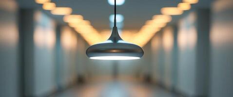 Lit pendant lamp in hallway with blurred background lights photo