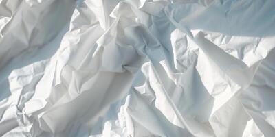 White crumpled paper forming an abstract background with intriguing shapes and shadows. photo