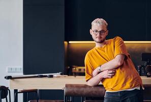 A man takes a brief rest from work in a modern startup coworking center, using the moment to recharge and relax with technology by his side. photo