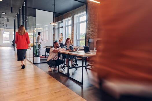 A diverse group of business professionals collaborates in a modern startup coworking center, utilizing a mix of paper-based and technological tools such as mobile phones and computers to collectively photo