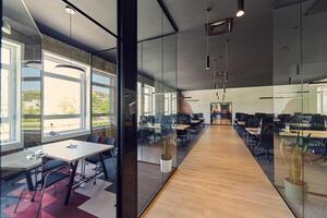 In a setting of modern, glass-walled business startup offices, the open, airy workspace reflects a contemporary and innovative ambiance, promising a dynamic environment for entrepreneurial growth photo
