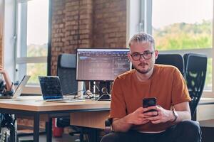 A modern businessman takes a relaxing break from work, using his smartphone to unwind and recharge during his pause photo