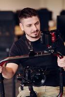 A professional videographer using modern equipment to capture compelling visuals, showcasing expertise and creativity in the art of production. photo