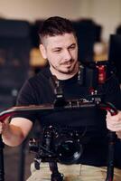 A professional videographer using modern equipment to capture compelling visuals, showcasing expertise and creativity in the art of production. photo