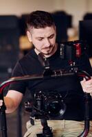 A professional videographer using modern equipment to capture compelling visuals, showcasing expertise and creativity in the art of production. photo