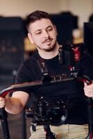 A professional videographer using modern equipment to capture compelling visuals, showcasing expertise and creativity in the art of production. photo