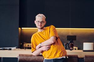 A man takes a brief rest from work in a modern startup coworking center, using the moment to recharge and relax with technology by his side. photo