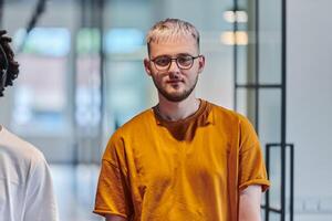 A modern portrait captures a blue-haired businessman wearing glasses, exuding creativity and professionalism, within the ambiance of a startup coworking office photo