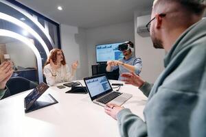 A diverse group of businessmen collaborates and tests a new virtual reality technology, wearing virtual glasses, showcasing innovation and creativity in their futuristic workspace photo