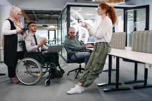 Young group of business people brainstorming together in a startup space, discussing business projects, investments, and solving challenges photo