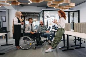 Young group of business people brainstorming together in a startup space, discussing business projects, investments, and solving challenges photo