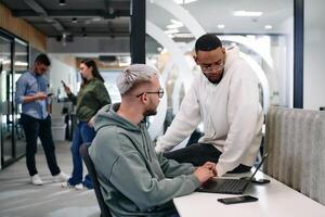 Young group of business people brainstorming together in a startup space, discussing business projects, investments, and solving challenges. photo