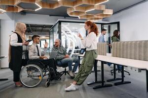 Young group of business people brainstorming together in a startup space, discussing business projects, investments, and solving challenges photo