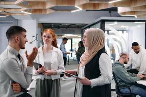 Young group of business people brainstorming together in a startup space, discussing business projects, investments, and solving challenges. photo