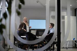 A diverse group of businessmen collaborates and tests a new virtual reality technology, wearing virtual glasses, showcasing innovation and creativity in their futuristic workspace photo