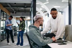 Young group of business people brainstorming together in a startup space, discussing business projects, investments, and solving challenges. photo
