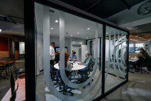 A diverse group of businessmen collaborates and tests a new virtual reality technology, wearing virtual glasses, showcasing innovation and creativity in their futuristic workspace photo