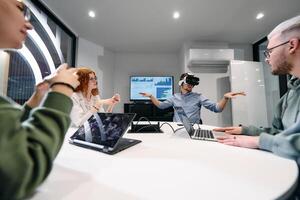 A diverse group of businessmen collaborates and tests a new virtual reality technology, wearing virtual glasses, showcasing innovation and creativity in their futuristic workspace photo
