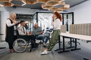 Young group of business people brainstorming together in a startup space, discussing business projects, investments, and solving challenges photo