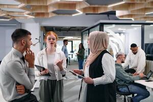 Young group of business people brainstorming together in a startup space, discussing business projects, investments, and solving challenges. photo