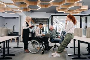 Young group of business people brainstorming together in a startup space, discussing business projects, investments, and solving challenges photo