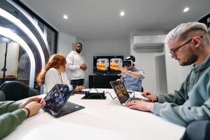 A diverse group of businessmen collaborates and tests a new virtual reality technology, wearing virtual glasses, showcasing innovation and creativity in their futuristic workspace photo