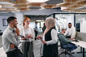 Young group of business people brainstorming together in a startup space, discussing business projects, investments, and solving challenges. photo