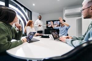A diverse group of businessmen collaborates and tests a new virtual reality technology, wearing virtual glasses, showcasing innovation and creativity in their futuristic workspace photo