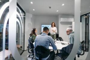A diverse group of businessmen collaborates and tests a new virtual reality technology, wearing virtual glasses, showcasing innovation and creativity in their futuristic workspace photo