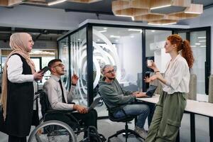 Young group of business people brainstorming together in a startup space, discussing business projects, investments, and solving challenges photo