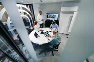 A diverse group of businessmen collaborates and tests a new virtual reality technology, wearing virtual glasses, showcasing innovation and creativity in their futuristic workspace photo