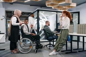 Young group of business people brainstorming together in a startup space, discussing business projects, investments, and solving challenges photo