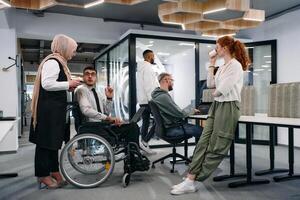 Young group of business people brainstorming together in a startup space, discussing business projects, investments, and solving challenges photo