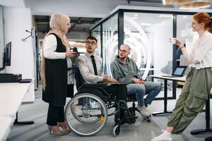Young group of business people brainstorming together in a startup space, discussing business projects, investments, and solving challenges photo