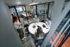A diverse group of businessmen collaborates and tests a new virtual reality technology, wearing virtual glasses, showcasing innovation and creativity in their futuristic workspace photo
