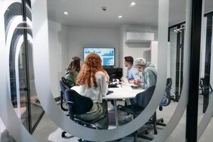 A diverse group of businessmen collaborates and tests a new virtual reality technology, wearing virtual glasses, showcasing innovation and creativity in their futuristic workspace photo