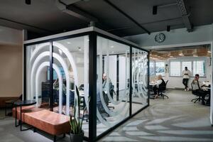 A diverse group of businessmen collaborates and tests a new virtual reality technology, wearing virtual glasses, showcasing innovation and creativity in their futuristic workspace photo