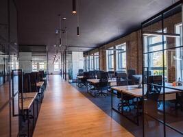 In a setting of modern, glass-walled business startup offices, the open, airy workspace reflects a contemporary and innovative ambiance, promising a dynamic environment for entrepreneurial growth photo