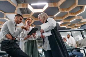 Young group of business people brainstorming together in a startup space, discussing business projects, investments, and solving challenges. photo
