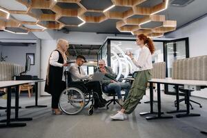 Young group of business people brainstorming together in a startup space, discussing business projects, investments, and solving challenges photo