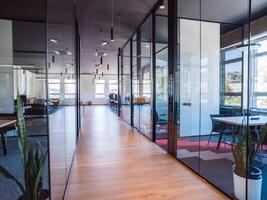 In a setting of modern, glass-walled business startup offices, the open, airy workspace reflects a contemporary and innovative ambiance, promising a dynamic environment for entrepreneurial growth photo