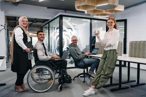 Young group of business people brainstorming together in a startup space, discussing business projects, investments, and solving challenges photo