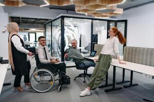 Young group of business people brainstorming together in a startup space, discussing business projects, investments, and solving challenges photo