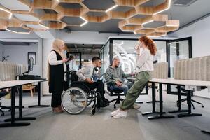 Young group of business people brainstorming together in a startup space, discussing business projects, investments, and solving challenges photo