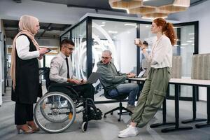 Young group of business people brainstorming together in a startup space, discussing business projects, investments, and solving challenges photo