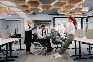 Young group of business people brainstorming together in a startup space, discussing business projects, investments, and solving challenges photo